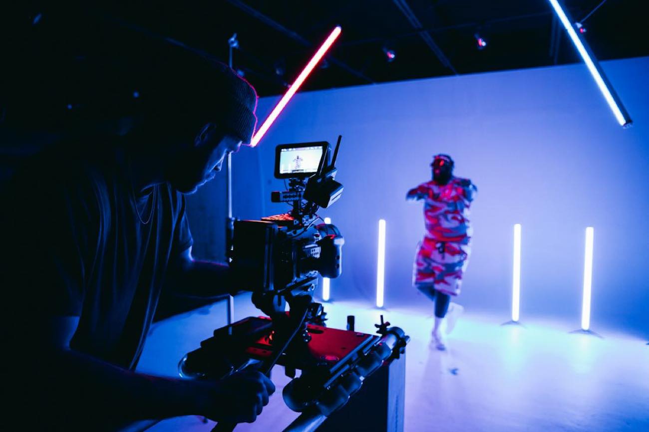 A creator filming to camera in a lit studio
